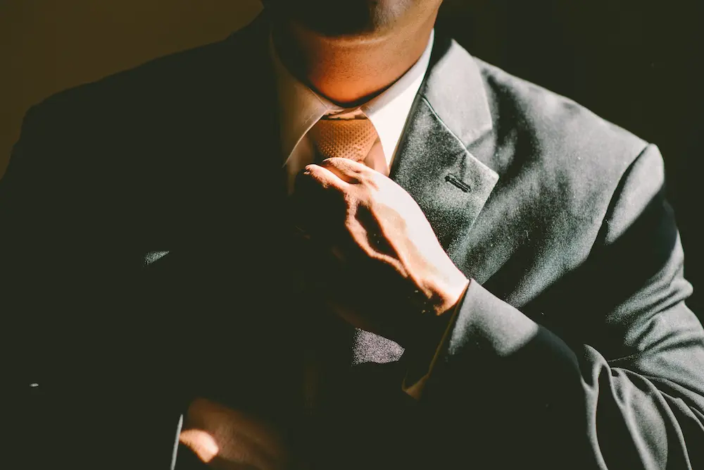 Elegant man loosening tie